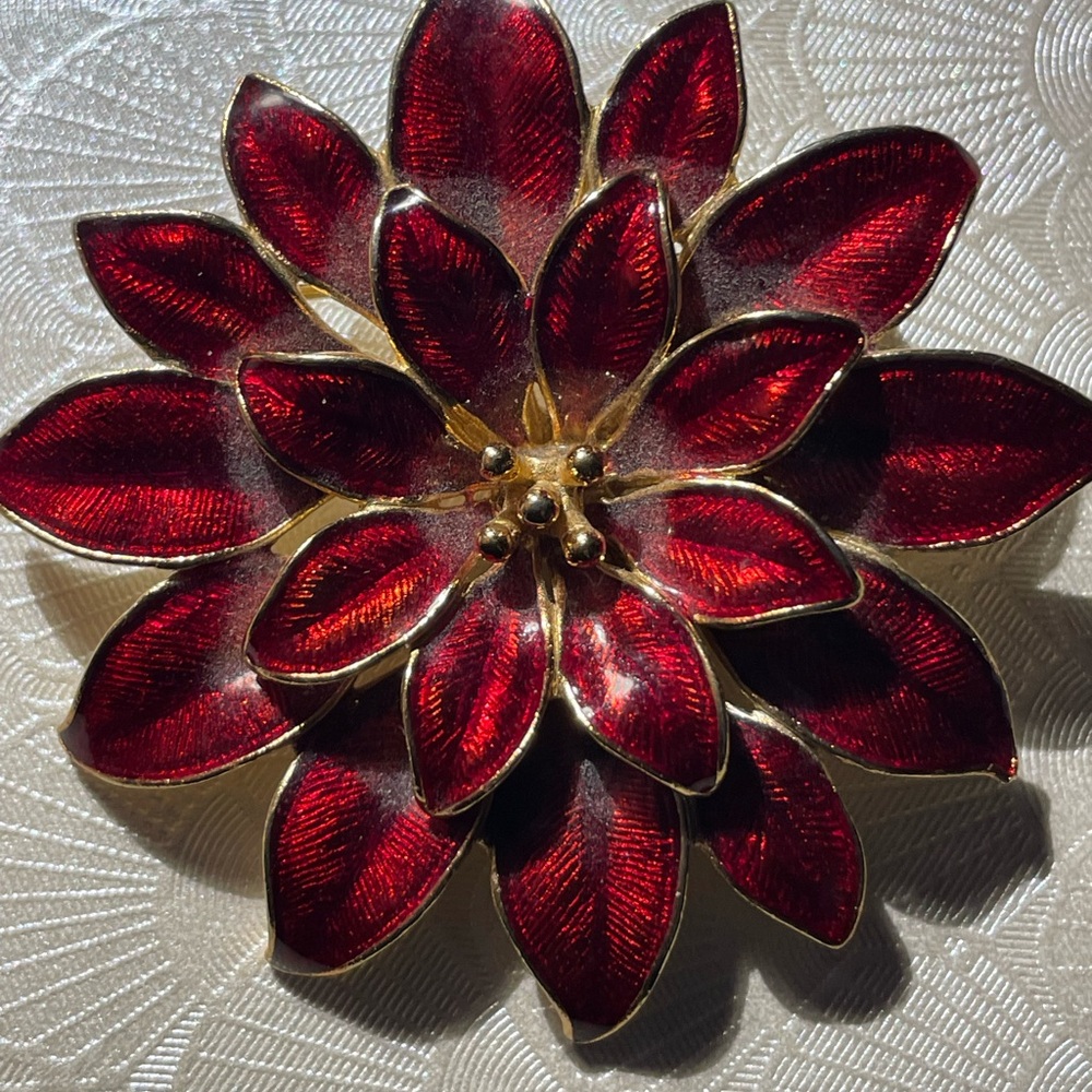 Vintage floral brooch featuring deep ruby-red translucent enamel petals